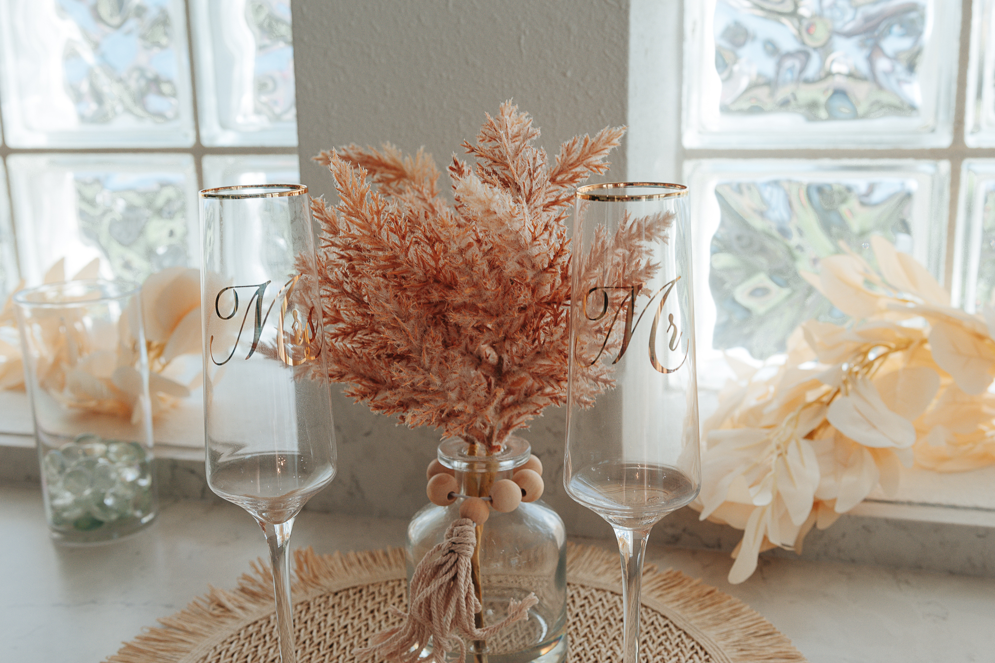 Bridal details including white wedding shoes, lace gown, and coordinated bouquet with eucalyptus