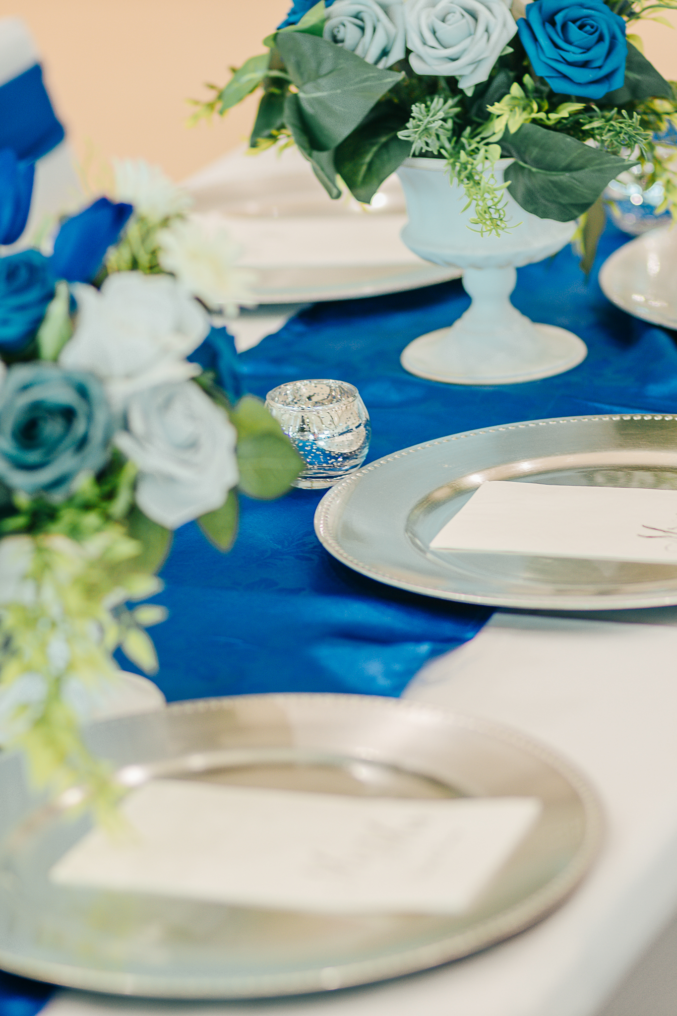 Detailed place setting with floral menu card, geometric plate, and coordinated wedding stationery