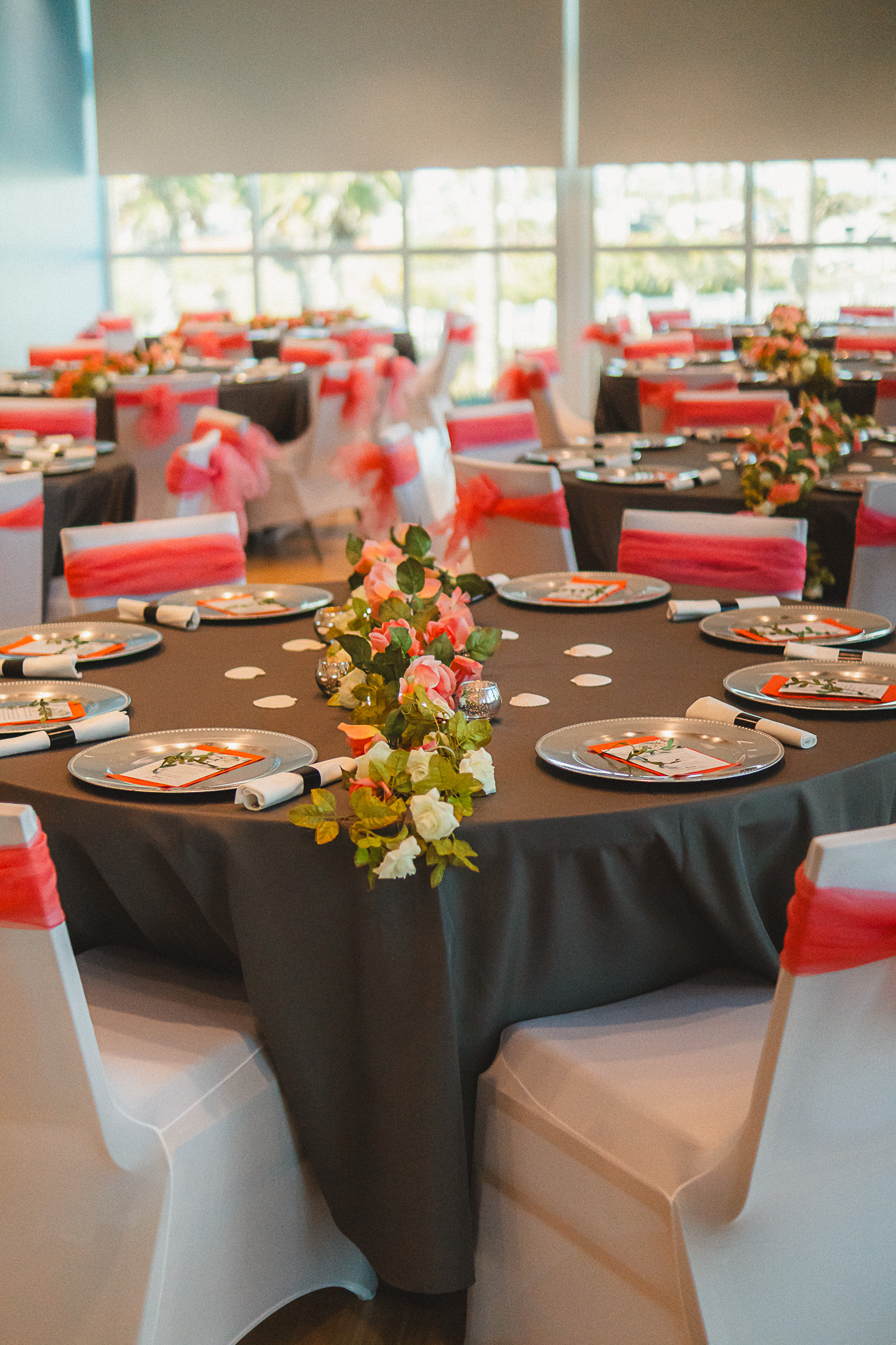 Elevated view of entire reception room with round tables, chair covers, and floral arrangements throughout