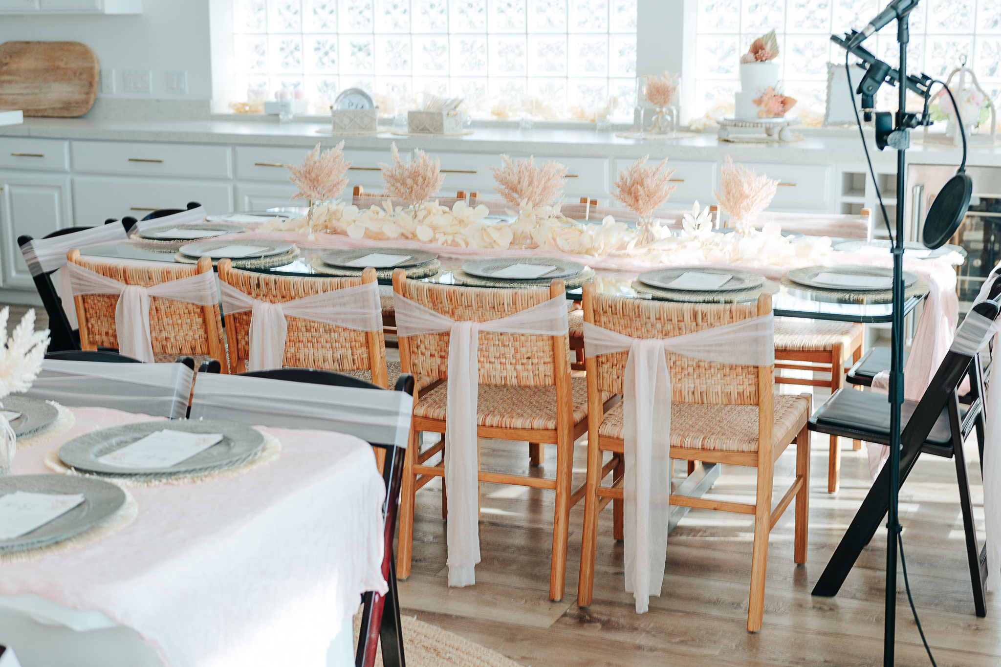 Elegant reception table design with layered linens, gold table numbers, and sophisticated floral centerpiece